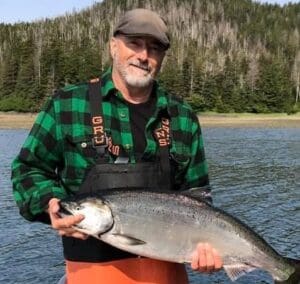 A man holding a large fish in his hands.