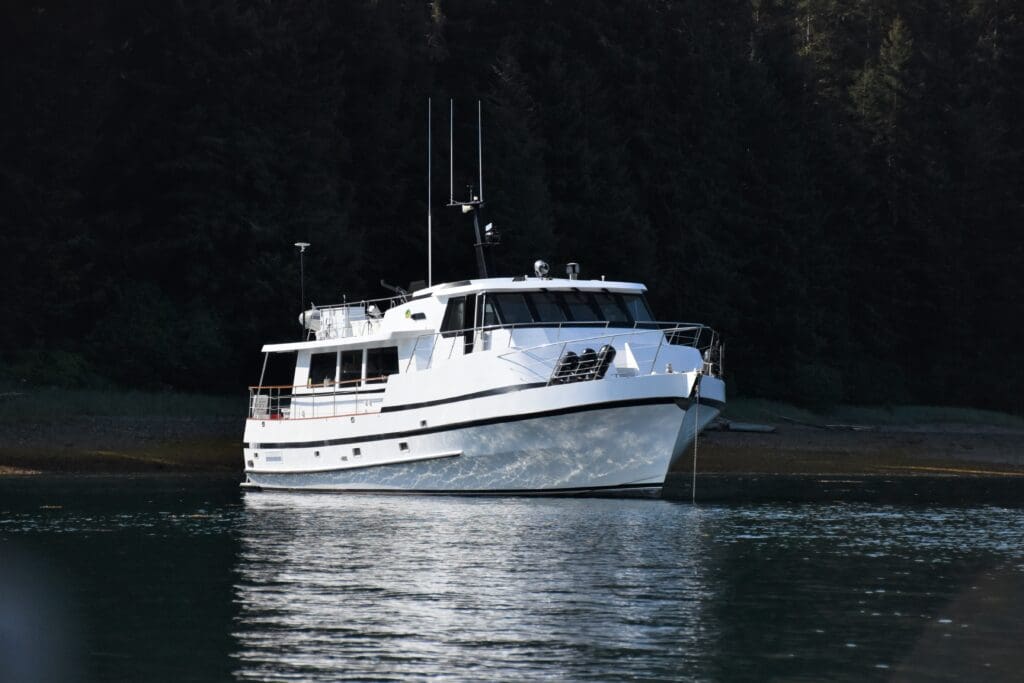 The Motor Yacht Midnight Sun anchored in beautiful cove in Southeast Alaska