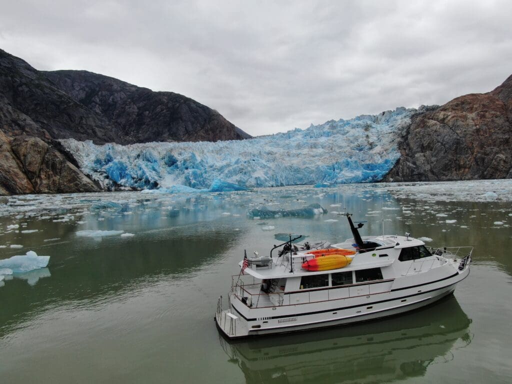 A boat in the water near some ice